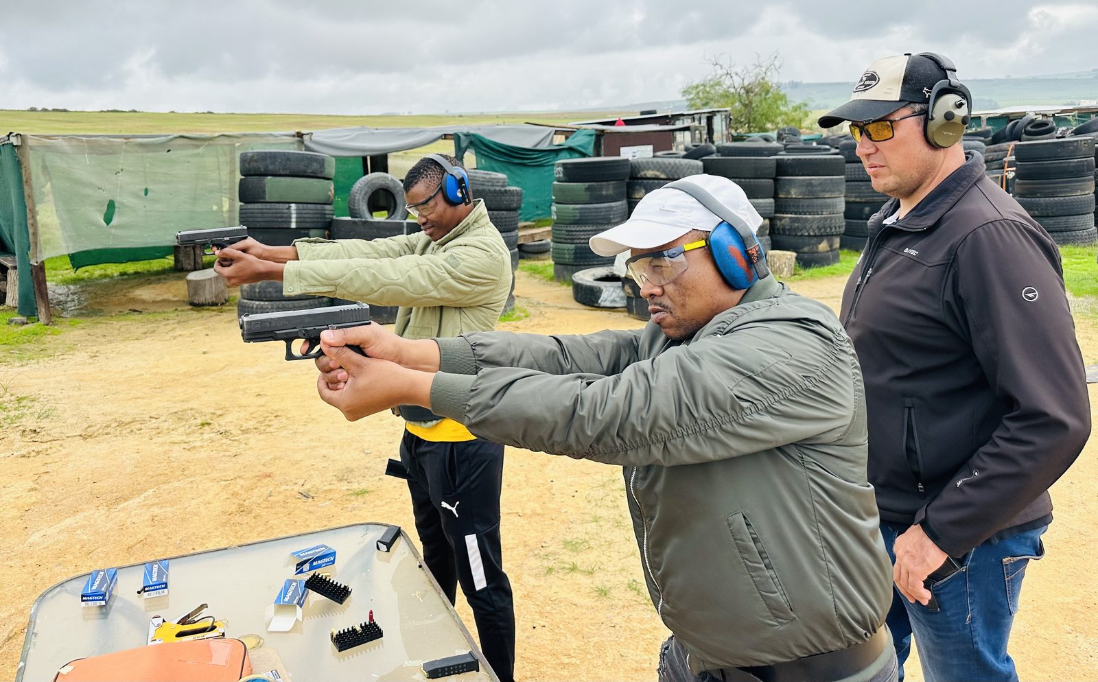Students practising safe handgun handling under supervision at the range